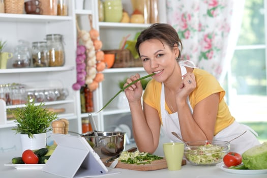 Portrait of a beautiful young woman cooking in the kitchen photo