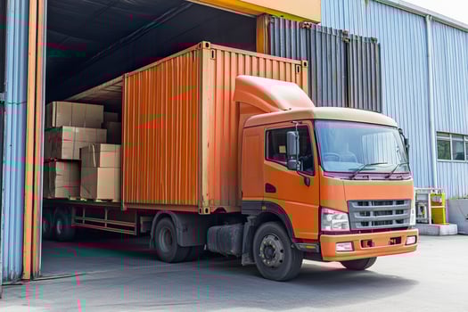A delivery truck is unloading cargo at a busy distribution facility in the morning photo
