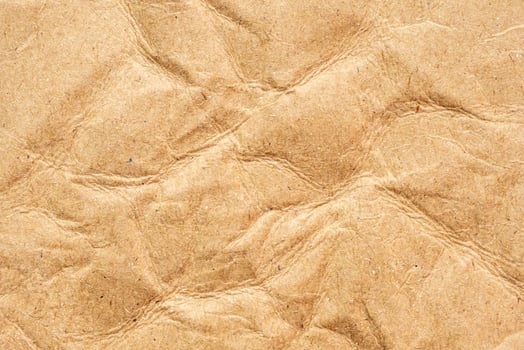 Abstract crumpled and creased recycle brown paper texture background photo