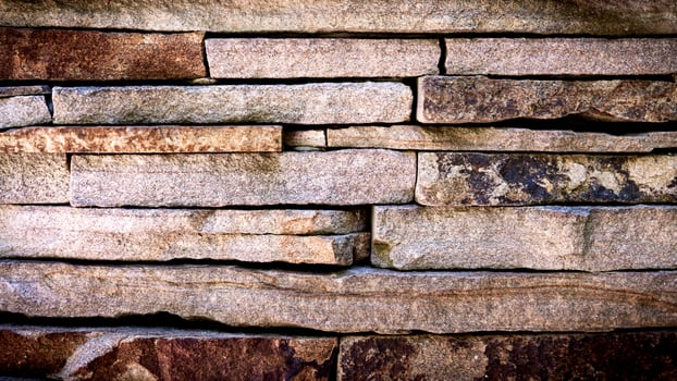 Part of a stone wall. Natural wallpaper. Selective focus. photo