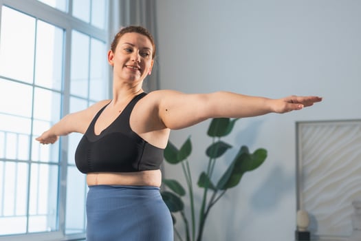 Fitness workout training. Woman practicing fitness at home. Plus size female doing sports exercise at home indoor. Girl in sportswear have workout weight training for weight loss. Sport and fitness photo