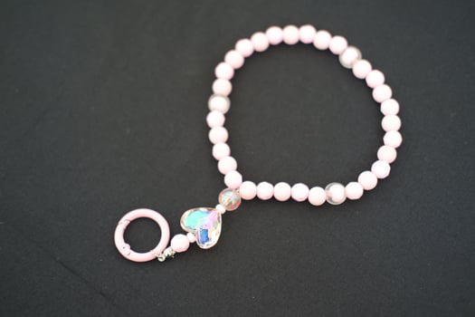 A beaded bracelet on a black surface. photo