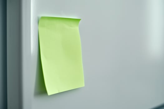 Sticky note on a white wall photo