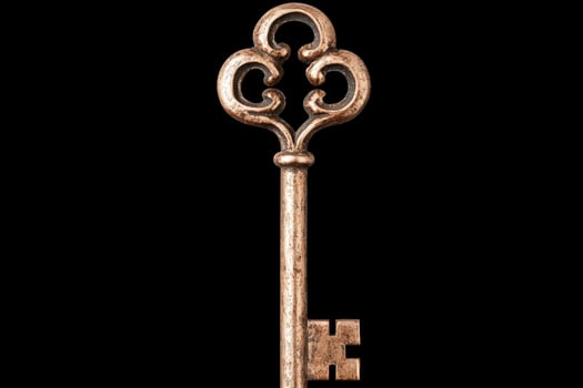 Antique skeleton key on black background photo