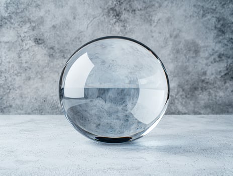 Reflective glass sphere on a concrete surface photo