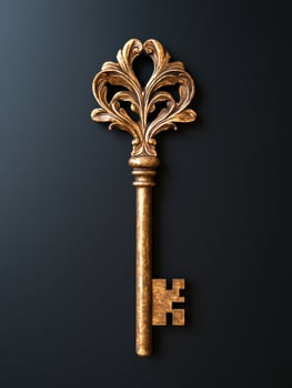 Ornate golden key on dark background photo