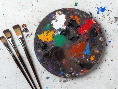 Vibrant artists palette with paint brushes photo