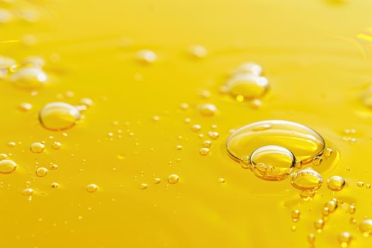 Vibrant yellow background with oil droplets photo