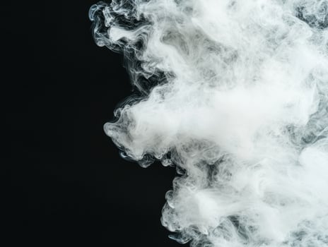 Swirling clouds of white smoke against a dark background photo
