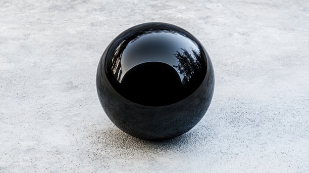 Reflective glass sphere on concrete surface photo