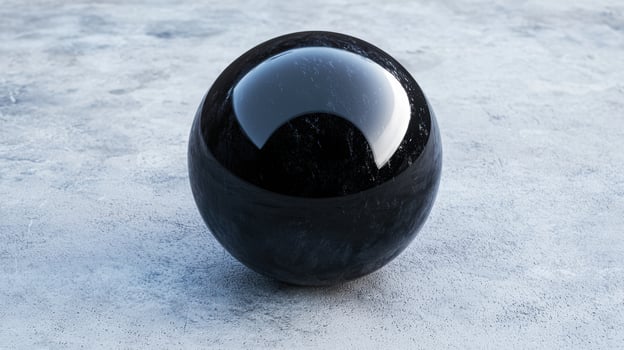 Reflective black glass sphere on icy surface photo