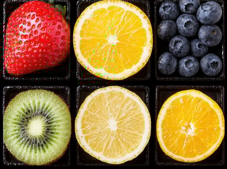 Assorted fresh fruits in a black tray photo