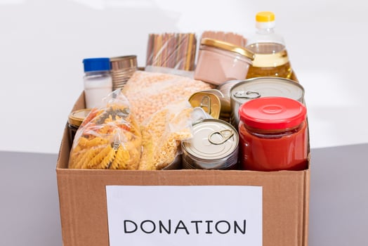 Donation Box of Free Food. Carton Box with Canned Food, Cereals and Grocery. Meal Reserves. Emergency Food Storage in Case of Crisis. Free Social Help, Blessings and Care. Strategic Food Supplies photo