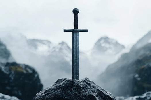 Sword in the stone against misty mountains photo
