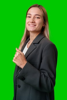 Young Woman in Black Blazer Smiles Against Green Screen photo