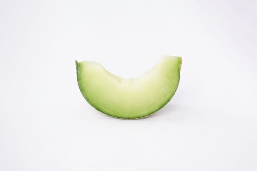Green cantaloupe melon with cut slice isolated on white background, green melon photo
