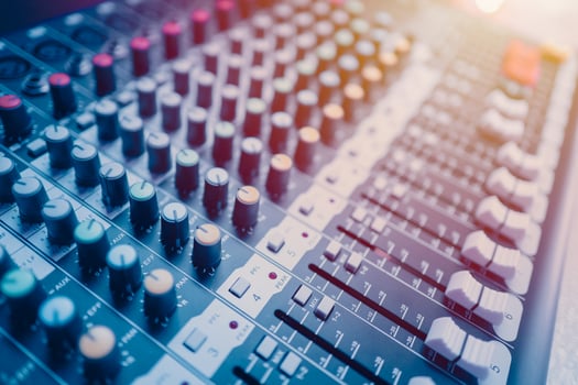Closeup multi channel digital sounds mixer for voice recording. Sound engineer tools editor in studio or stage show instruments blue color tone photo