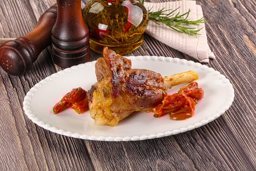 Baked lamb shank with vegetables photo