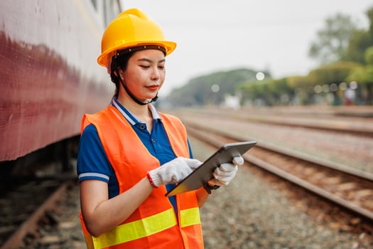 Train locomotive engineer women worker. Young teen Asian working check service maintenance train using tablet computer software. photo
