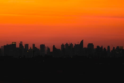 shadow silhouette city on orange sunset sky dusk dawn for hot metro business urban background photo
