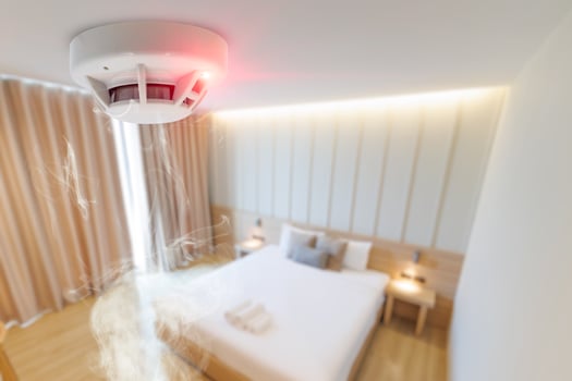 hotel bad room smoke fire detector install at ceiling. fire safety device for home photo