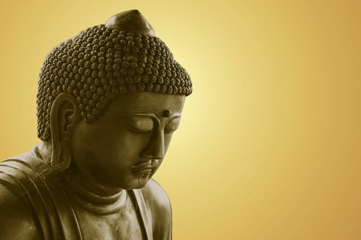 Peace Buddha statue. Zen Buddha isolated copy space orange color tone. photo
