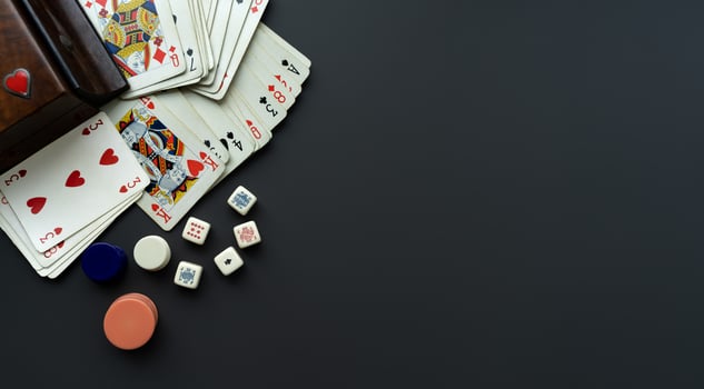 Playing cards and dice on a dark grey background. photo