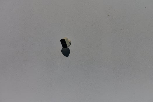 A solitary paintbrush floating above a pale surface, capturing a moment of artistic inspiration in the studio photo