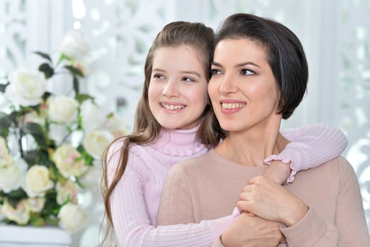 Little girl with her mother posing at home photo