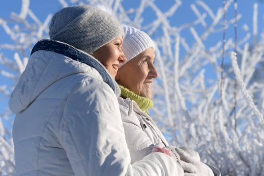 Beautiful elderly woman and her daughter enjoy winter together. photo