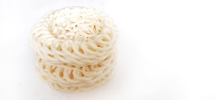 White noodle crackers or kerupuk putih or kerupuk warung made from tapioca flour, snack food from Indonesia isolated on white background photo