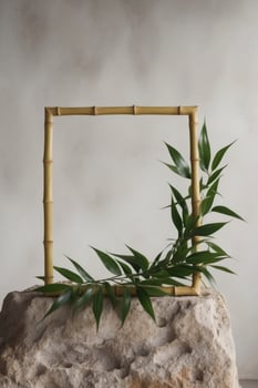 Bamboo frame with green plant on top of rock photo