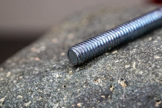 Close up of a screw on a rock photo