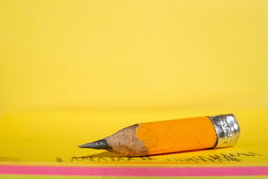 small pencil placed on a paper note photo