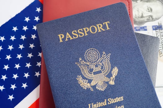 US passport issued to citizen and national of the United States of America to travel in most countries outside with USA flag and dollar money. photo