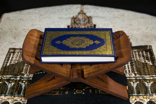 a quran sitting on a wooden stand photo