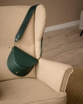 a green leather bag on a chair photo