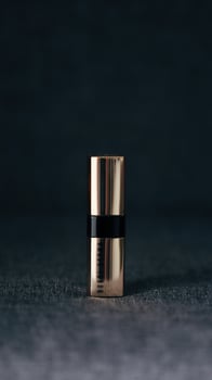 a lipstick on a black background photo