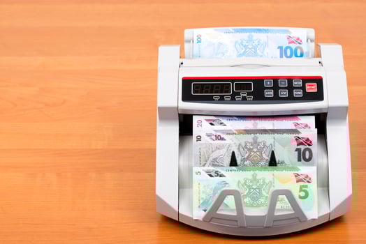 Trinidad and Tobago money - dollar in the counting machine photo
