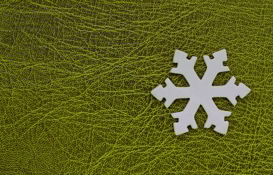 Artificial Snowflake Isolated On Green Patterned Surface With Empty Space At A Side Of Image. Winter Background Design. White 3D Printed Snowflake On Green photo