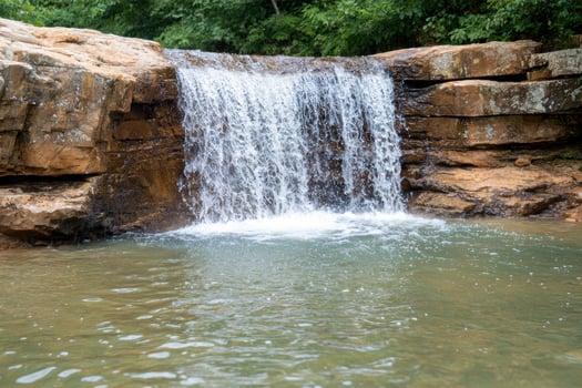Serene waterfall in lush forest photo
