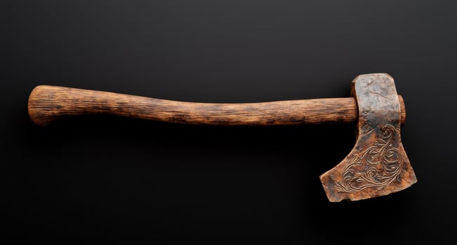 Ornate wooden axe head on dark background photo