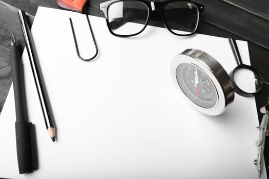 Blank notebook and pencil with glasses on wooden table photo