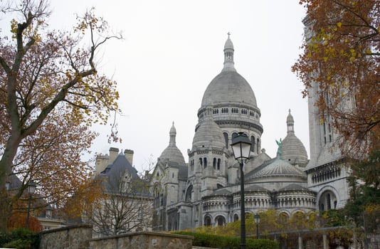 Sacre-Cour Basilica Fram by Golden Autumn Trees and Leaf Covered Ground in Paris photo