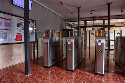Spain, Valencia, March 29, 2024. Modern Turnstile Entrance in a Public Transport Station During the Morning Rush Hour photo