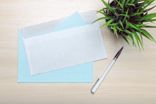 Photo of blank envelope on a wooden background