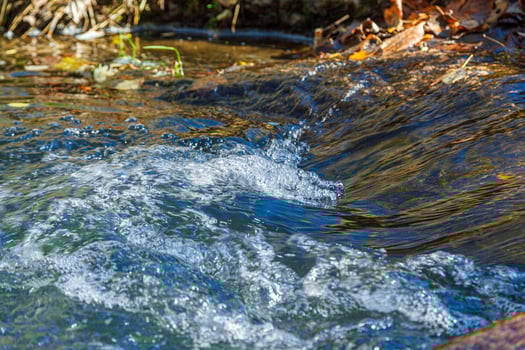 flow of water and spray from a stone photo