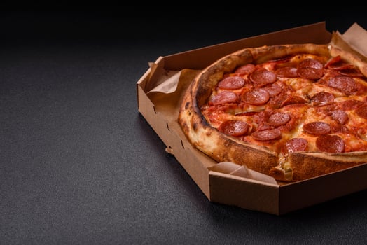 Pepperoni pizza with sausage, mozzarella cheese, tomatoes, salt and spices photo