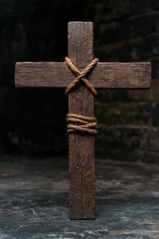 Weathered wooden cross with rope photo