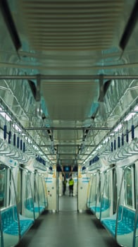 Empty cabin of a modern passenger train. Empty seats inside train cabin, corridor view, no people. Modern european economy class fast train interior. Inside of high speed train compartment photo